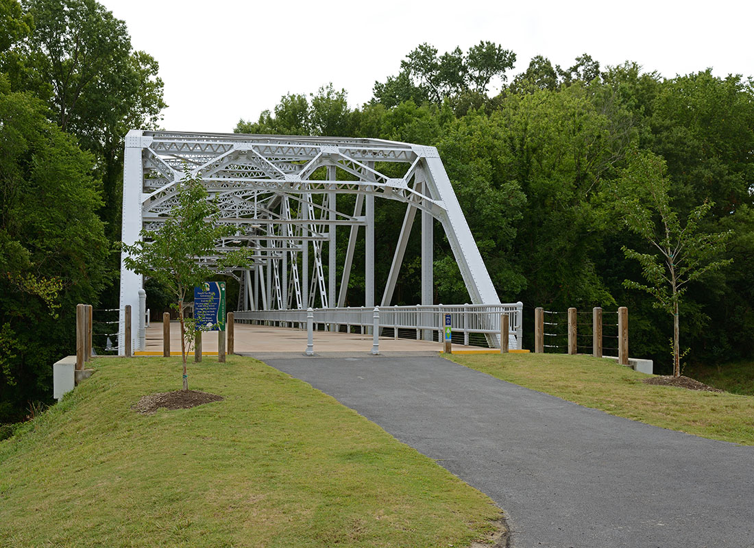Greenville, NC - Steel Bridge Across the River Surrounded by Green Foliage in Greenville North Carolina